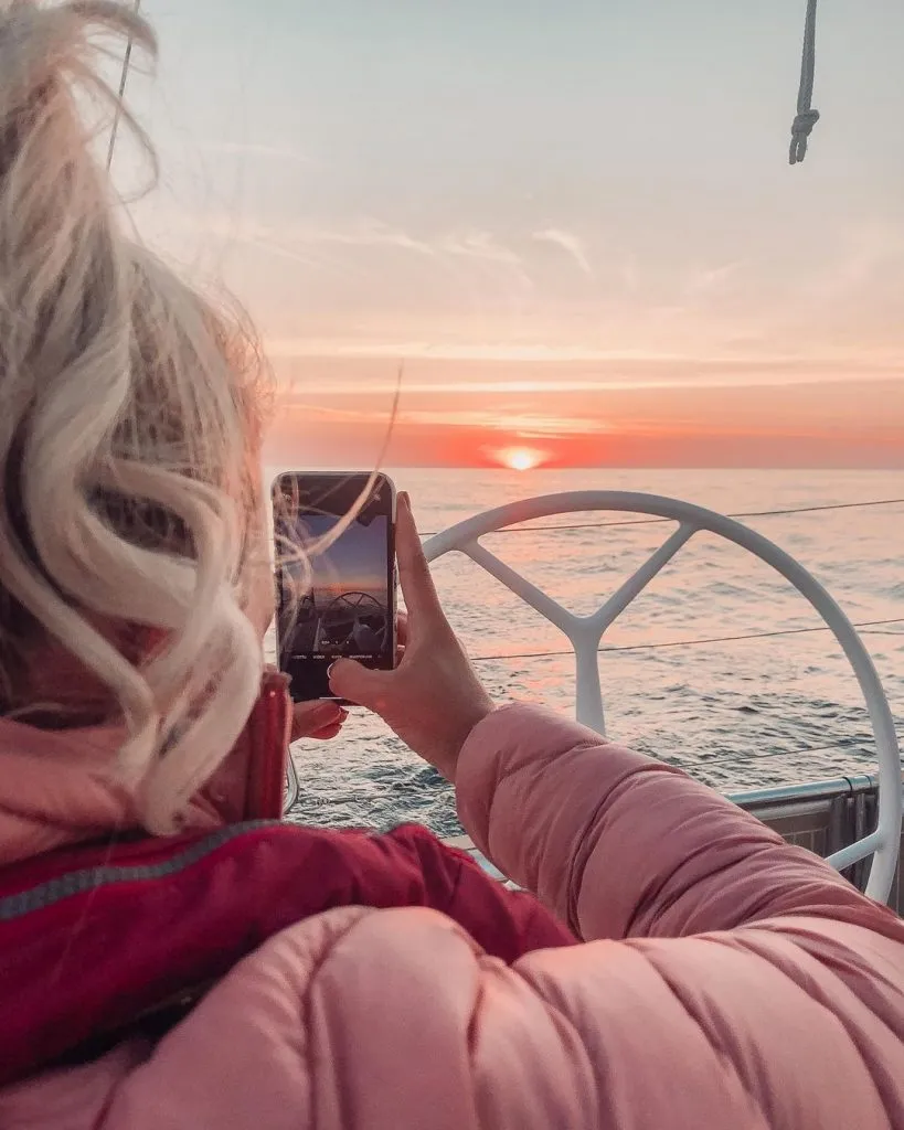 Charlotte photographing the sunset on s/y Charlotte, Hanse 388.